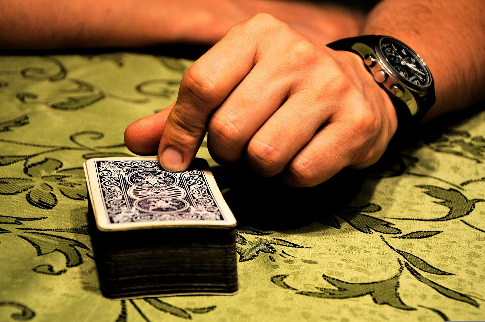 Dealer hand with chips at a Knavewick card table